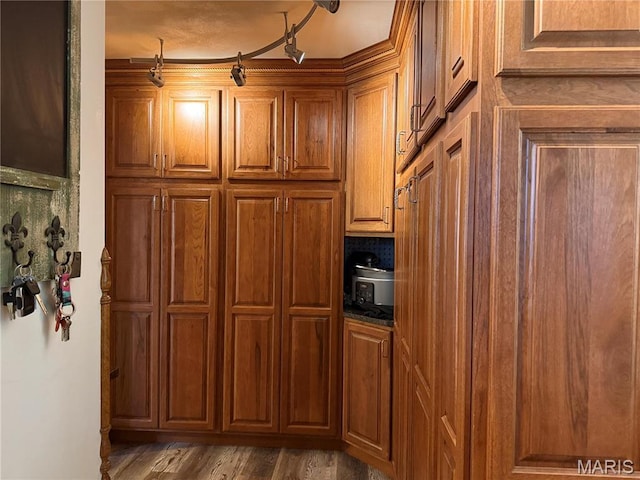 kitchen with brown cabinets and wood finished floors