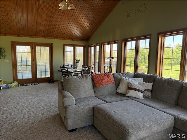 living area featuring carpet flooring, wood ceiling, baseboards, and high vaulted ceiling