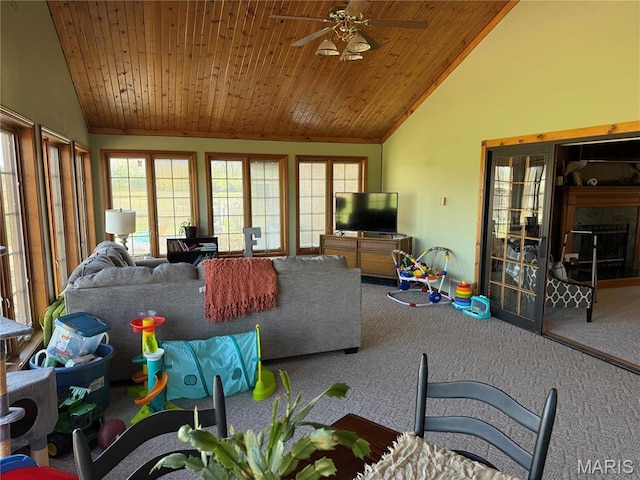carpeted living room featuring vaulted ceiling, plenty of natural light, ceiling fan, and wooden ceiling