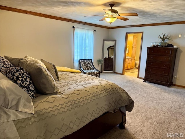 bedroom with light colored carpet, baseboards, ensuite bathroom, ceiling fan, and ornamental molding