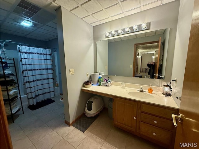 bathroom with tile patterned floors, vanity, and baseboards