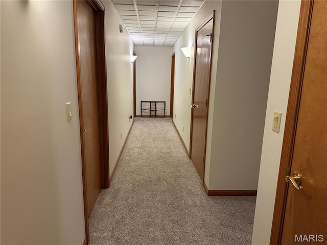 hall with carpet flooring and baseboards
