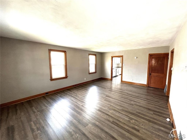 102 E 1st St, Waterloo, IL 62298 - spare room featuring baseboards and dark wood-style flooring