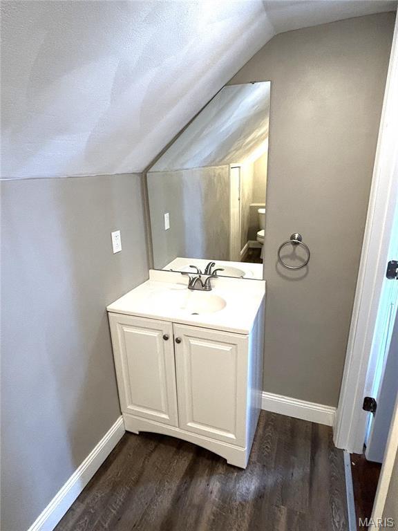 102 E 1st St, Waterloo, IL 62298 - bathroom featuring lofted ceiling, wood finished floors, baseboards, and vanity