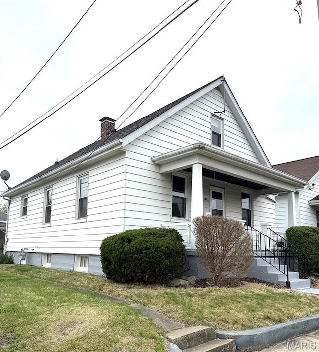 102 E 1st St, Waterloo, IL 62298 - view of front of home with a front yard, a porch, and a chimney