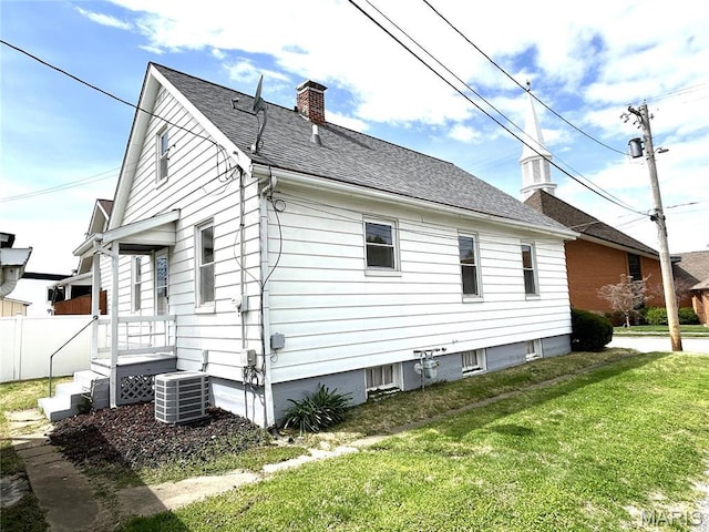 102 E 1st St, Waterloo, IL 62298 - view of side of property featuring a chimney, central AC unit, and a shingled roof