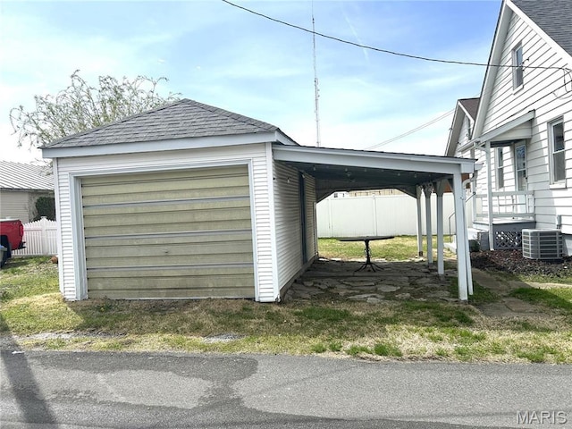 102 E 1st St, Waterloo, IL 62298 - garage with a carport, central AC unit, and fence