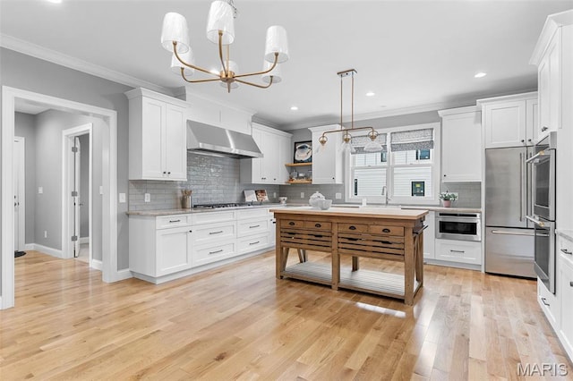 9870 E Concord Rd, Saint Louis, MO 63128 - kitchen featuring wall chimney exhaust hood, crown molding, open shelves, backsplash, and white cabinets