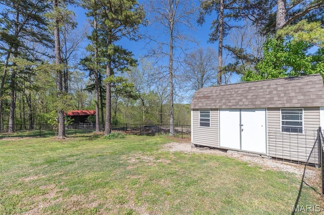 view of yard featuring a storage unit and an outbuilding