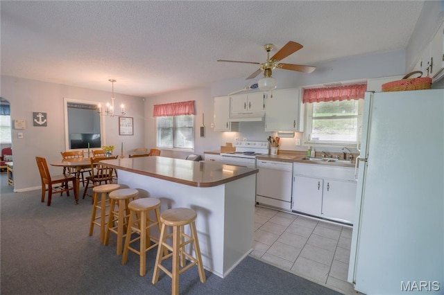 1207 Napoleon Dr, Bonne Terre, MO 63628 - kitchen with white appliances, white cabinets, a center island, a kitchen breakfast bar, and ceiling fan