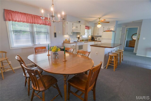 1207 Napoleon Dr, Bonne Terre, MO 63628 - dining room featuring dark carpet, ceiling fan, and a chandelier