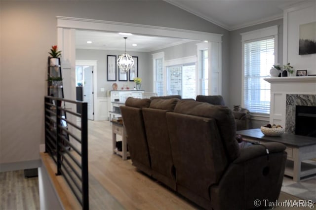 303 Orange Bowl Dr, Cape Girardeau, MO 63701 - living room with light wood finished floors, a chandelier, a fireplace, ornamental molding, and recessed lighting
