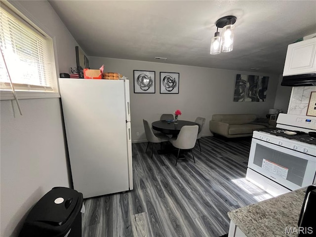 102 W Adams Dr, Cahokia, IL 62206 - kitchen with white appliances, dark wood-type flooring, ventilation hood, white cabinets, and light countertops