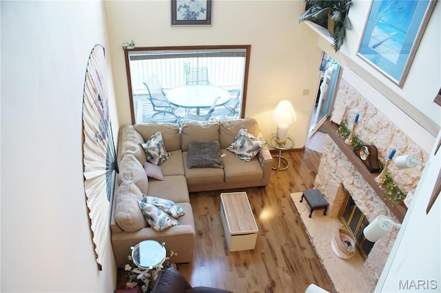 64 W Windjammer Ct Unit 2D, Lake Ozark, MO 65049 - living room featuring a glass covered fireplace and wood finished floors
