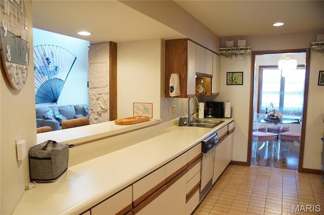64 W Windjammer Ct Unit 2D, Lake Ozark, MO 65049 - kitchen with a sink, white dishwasher, light countertops, light tile patterned flooring, and recessed lighting