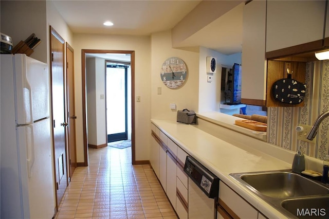 64 W Windjammer Ct Unit 2D, Lake Ozark, MO 65049 - kitchen featuring white appliances, a sink, white cabinetry, light tile patterned floors, and light countertops