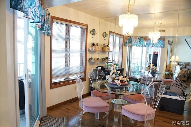 64 W Windjammer Ct Unit 2D, Lake Ozark, MO 65049 - dining room featuring a chandelier, wood finished floors, and baseboards