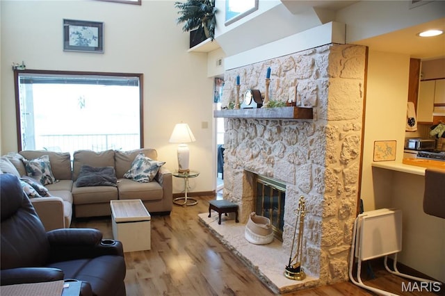 64 W Windjammer Ct Unit 2D, Lake Ozark, MO 65049 - living room featuring light wood-style floors, plenty of natural light, a fireplace, and baseboards