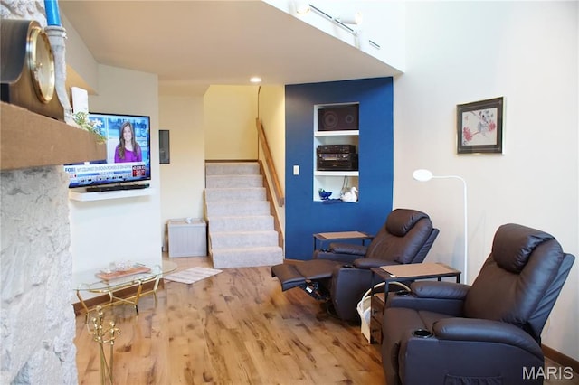 64 W Windjammer Ct Unit 2D, Lake Ozark, MO 65049 - sitting room featuring wood finished floors, stairway, and built in shelves