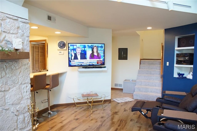 64 W Windjammer Ct Unit 2D, Lake Ozark, MO 65049 - living area featuring wood finished floors, stairs, baseboards, electric panel, and recessed lighting