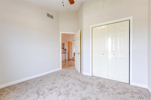 190 Bay Meadow Cir, Moro, IL 62067 - unfurnished bedroom with carpet, baseboards, a high ceiling, a closet, and a ceiling fan