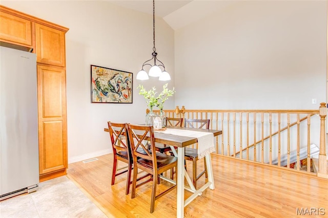 190 Bay Meadow Cir, Moro, IL 62067 - dining room with baseboards, light wood-style flooring, and high vaulted ceiling
