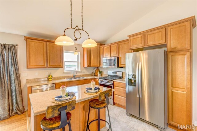 190 Bay Meadow Cir, Moro, IL 62067 - kitchen with stainless steel appliances, a sink, a center island, lofted ceiling, and a kitchen bar