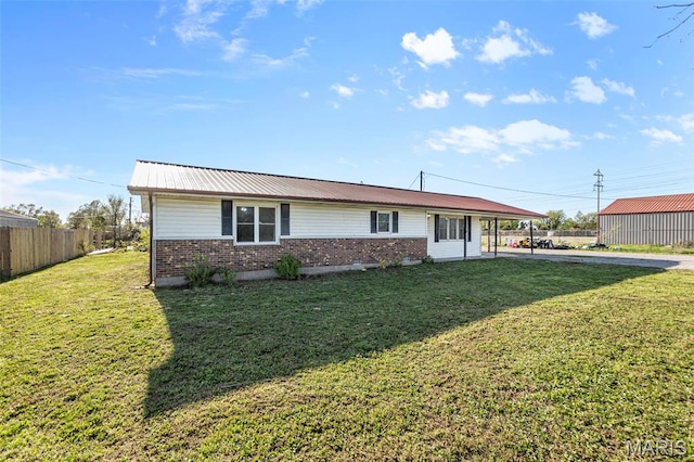 view of front of house with brick siding, concrete driveway, an attached carport, and metal roof