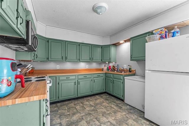 kitchen featuring freestanding refrigerator, a textured ceiling, butcher block countertops, electric range, and washer / dryer