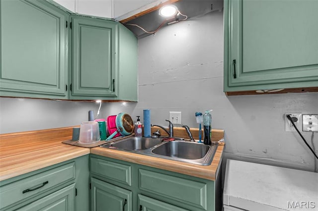 kitchen with a sink and green cabinetry