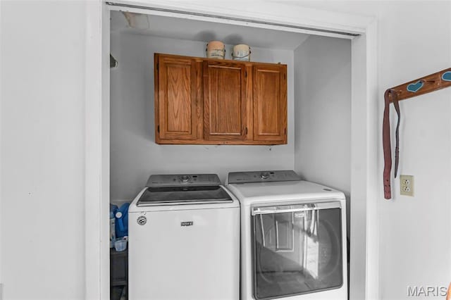 washroom featuring cabinet space and washer and dryer