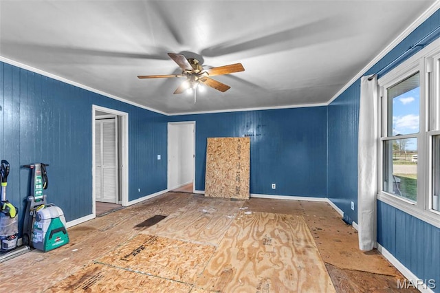 unfurnished bedroom featuring ornamental molding, baseboards, and a ceiling fan