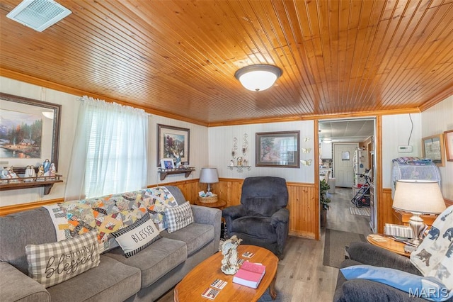 712 Nickey St, Poplar Bluff, MO 63901 - living area with wood ceiling, crown molding, wood finished floors, a wainscoted wall, and wood walls