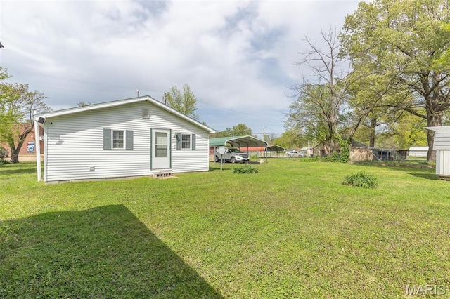 712 Nickey St, Poplar Bluff, MO 63901 - rear view of house with a carport and a yard