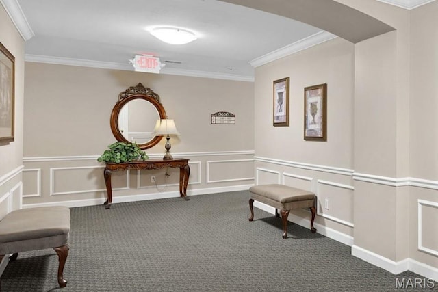 corridor with carpet, arched walkways, ornamental molding, a decorative wall, and wainscoting