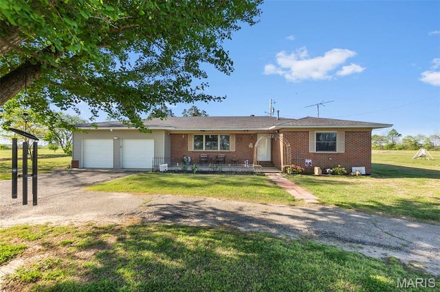 12572 Rd 516, Senath, MO 63876 - ranch-style home with an attached garage, driveway, brick siding, and a front yard