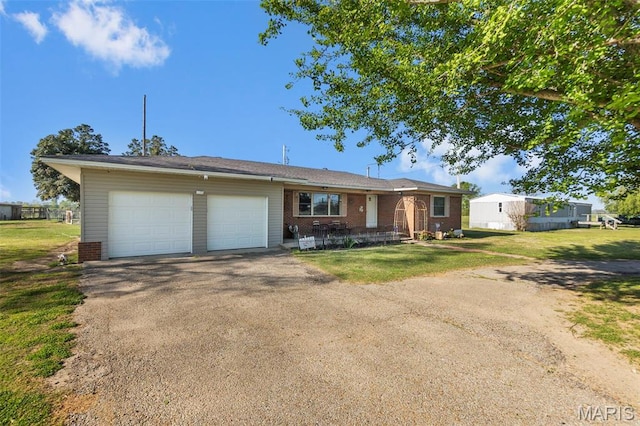 12572 Rd 516, Senath, MO 63876 - ranch-style home featuring an attached garage, asphalt driveway, a front lawn, and brick siding