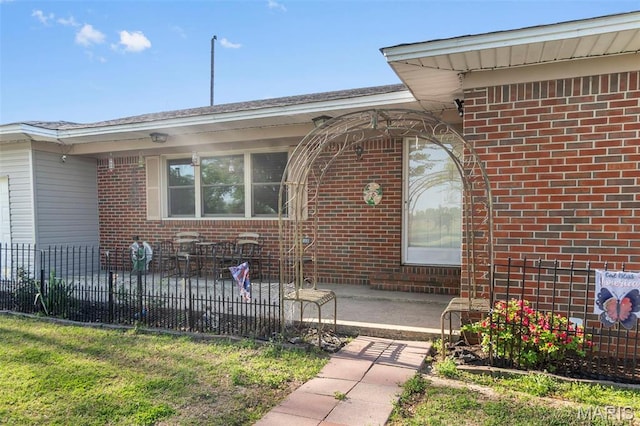 12572 Rd 516, Senath, MO 63876 - property entrance with brick siding, fence, and a patio area