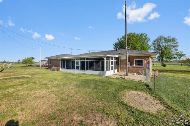12572 Rd 516, Senath, MO 63876 - back of property featuring a sunroom, brick siding, and a yard