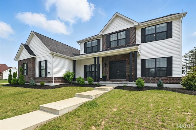 2202 Dartmouth Gate Cir, Wildwood, MO 63011 - view of front of property featuring brick siding, a front yard, and covered porch