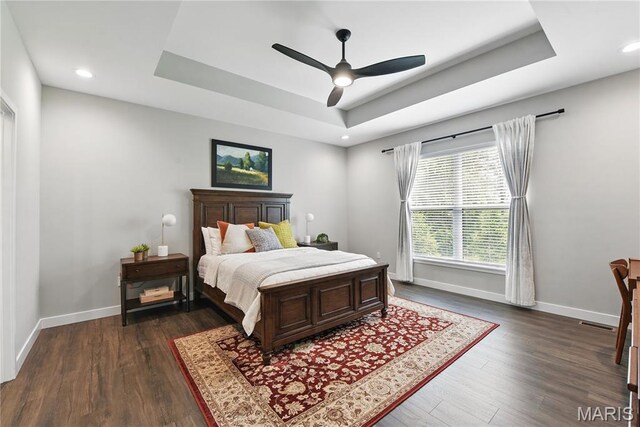 2202 Dartmouth Gate Cir, Wildwood, MO 63011 - bedroom featuring a raised ceiling, baseboards, dark wood-style flooring, and recessed lighting