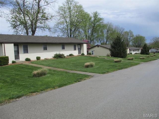 ranch-style house with a front lawn