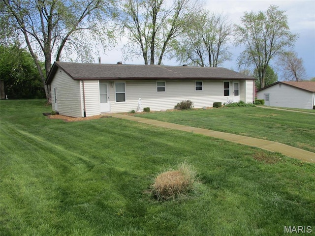 rear view of property with a yard