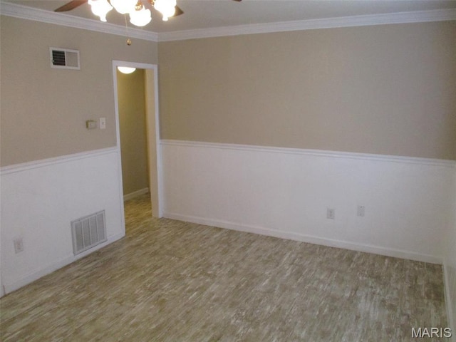 unfurnished room with a ceiling fan, wood finished floors, and ornamental molding