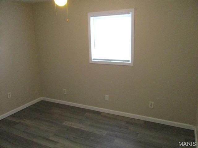 unfurnished room with wood finished floors, baseboards, and a ceiling fan
