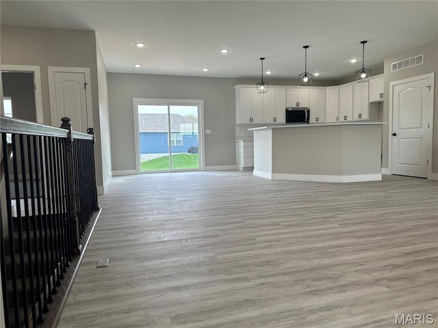 208 Pacific Ave, Union, MO 63084 - unfurnished living room with recessed lighting, baseboards, and light wood finished floors