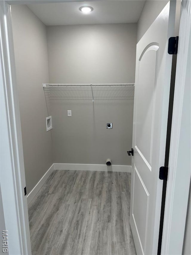 208 Pacific Ave, Union, MO 63084 - laundry room with electric dryer hookup, wood finished floors, baseboards, and washer hookup