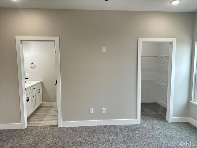 208 Pacific Ave, Union, MO 63084 - unfurnished bedroom with light carpet, a walk in closet, baseboards, and a closet