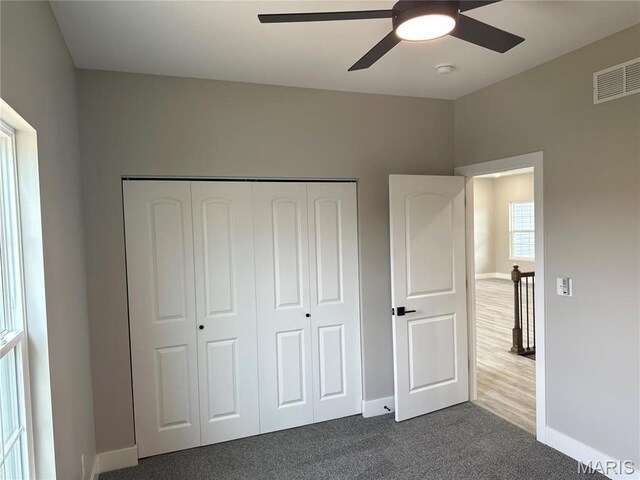 208 Pacific Ave, Union, MO 63084 - unfurnished bedroom with baseboards, a closet, dark colored carpet, and a ceiling fan
