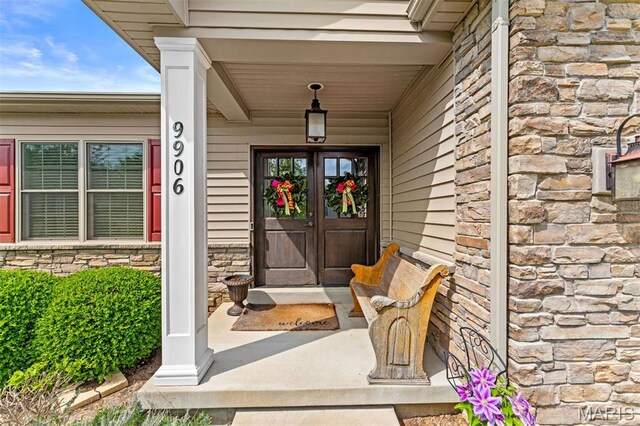 9906 Sappington Rd, Saint Louis, MO 63128 - doorway to property with stone siding and a porch